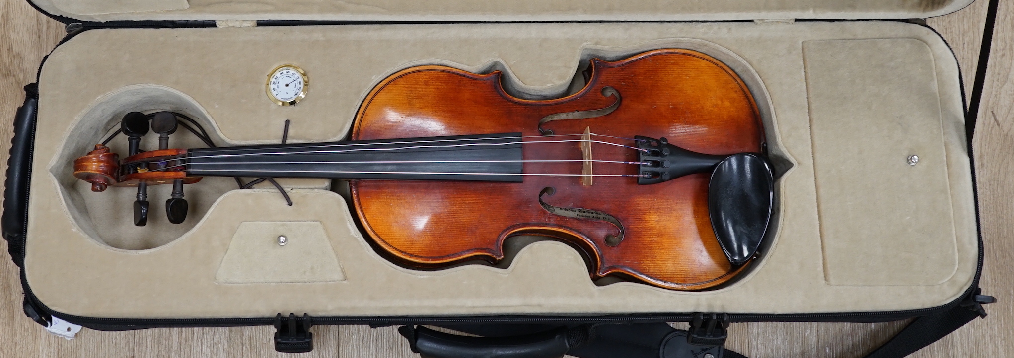 A Czechoslovakian student’s violin with Stradivarius label inside the body, length of body, 35.5cm, in a good modern case with fitted hygrometer